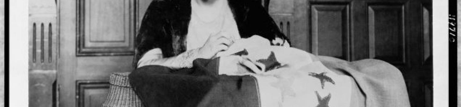Alice Paul sewing a suffrage banner