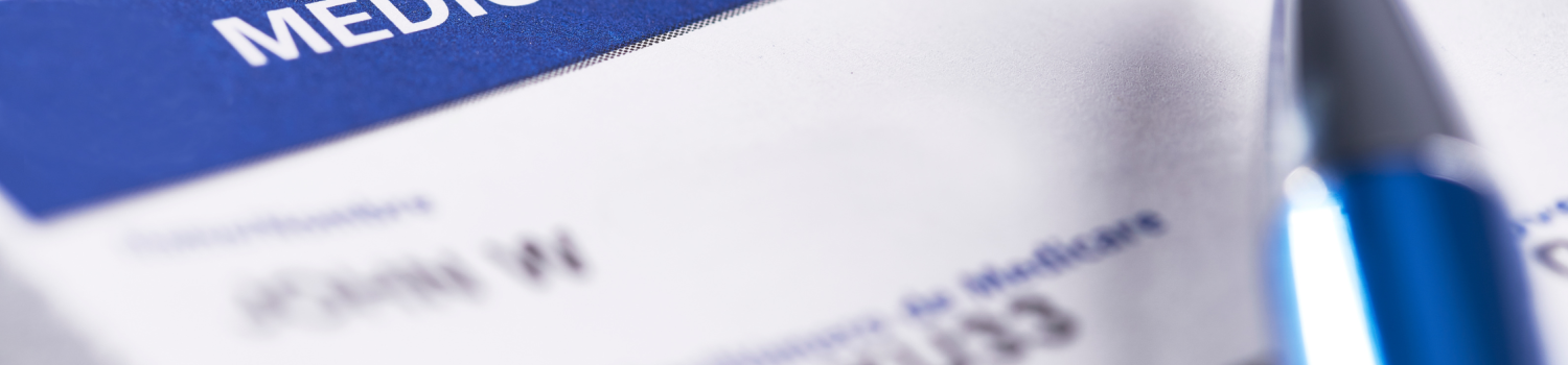 Close up of Medicare insurance card with pen